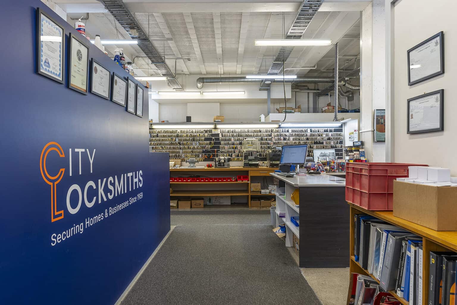 Office area view of City Locksmiths customer counter and workshop.