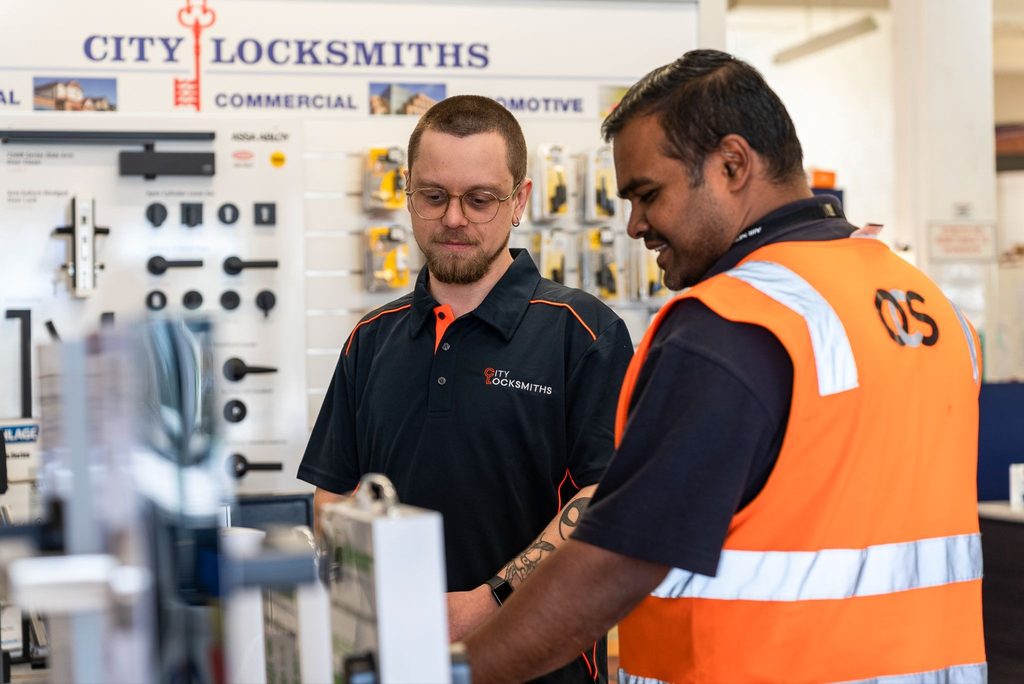 Locksmith Technician Max providing a customer with advice on digital locks at our City Locksmiths Auckland retail store.