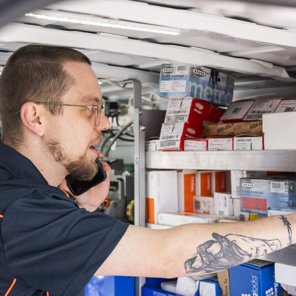 Technician working inside locksmith van.